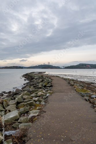 Concrete and boulder jetty with an ocean background