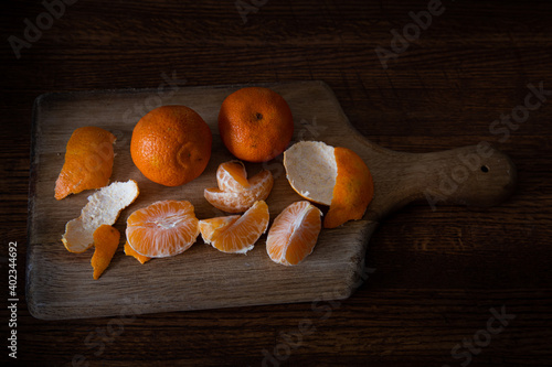 mandarin oranges on wooden cutting board