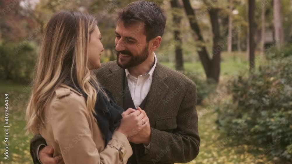 Handsome young couple walking in the autumn park Handsome young couple walking in the autumn park