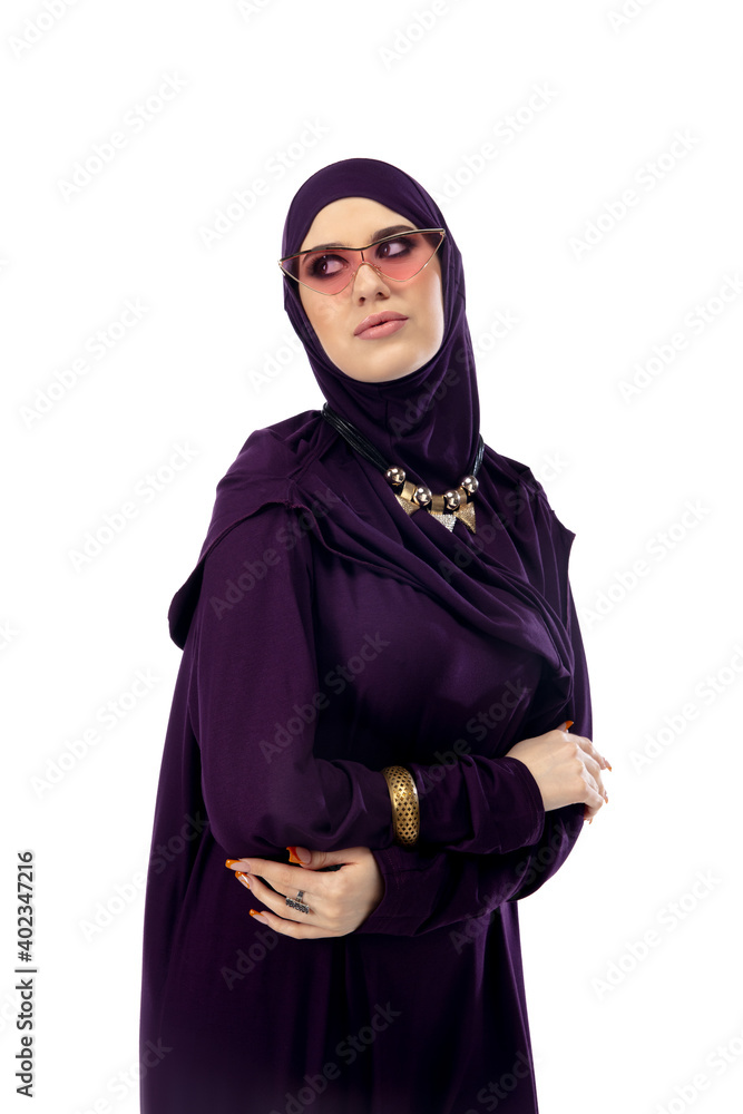 Eyewear. Beautiful arab woman posing in stylish hijab on studio background with copyspace for ad. Fashion, beauty, style concept. Female model with trendy make up, manicure and accessories. Eyewear. Beautiful arab woman posing in stylish hijab on studio background with copyspace for ad. Fashion, beauty, style concept. Female model with trendy make up, manicure and accessories.