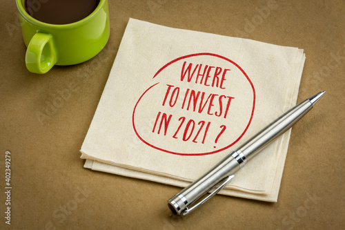 Where to invest in 2021? A question on napkin with cup of coffee. Stock market and financial planning concept.