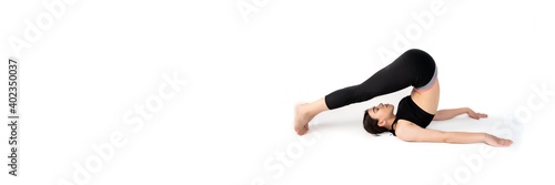 Young woman doing yoga practice isolated on white background. Flexible fit female body. Banner panoramic. Copy space for text message. High resolution sharp photo.