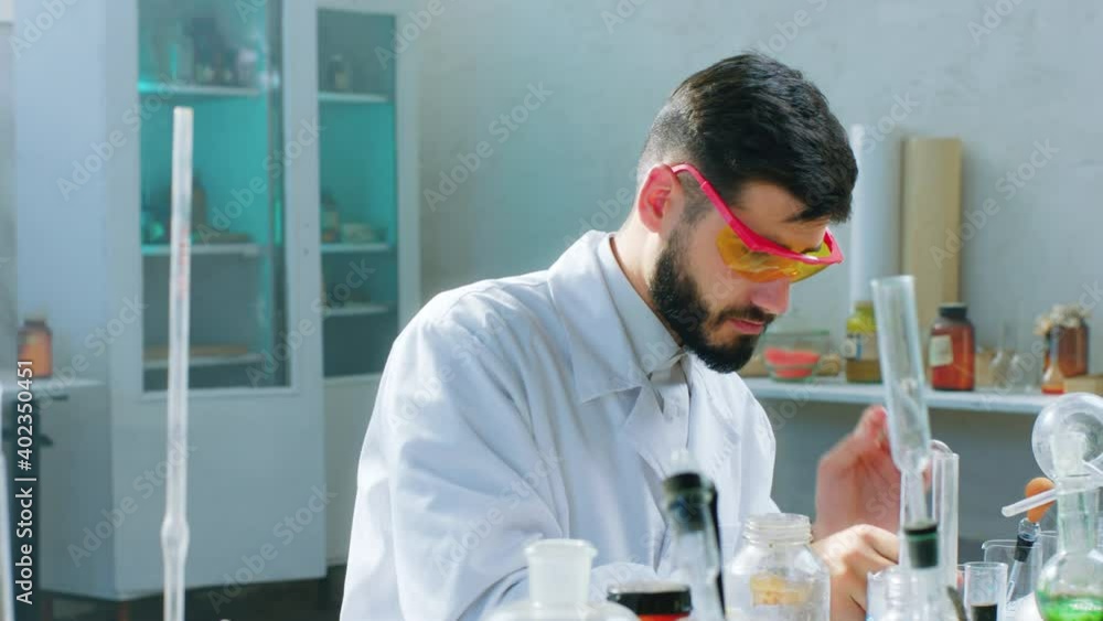 In the biochemical laboratory man scientist take the protective glass before start to make a test experiment with chemical substance closeup to the camera. 4k In the biochemical laboratory man scientist take the protective glass before start to make a test experiment with chemical substance closeup to the camera. 4k