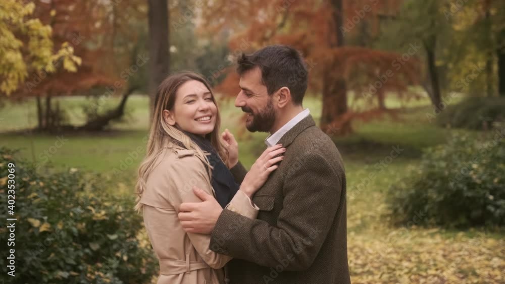 Handsome young couple walking in the autumn park Handsome young couple walking in the autumn park