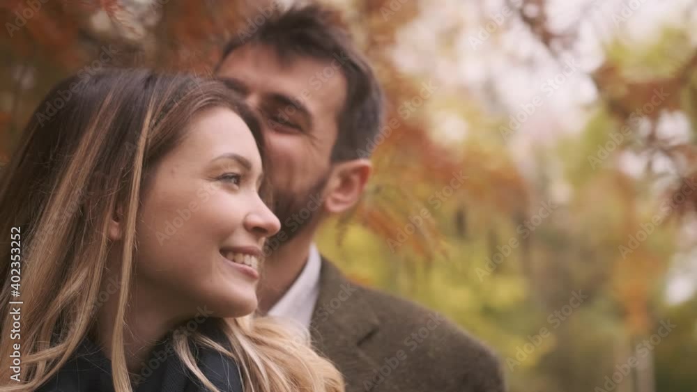 Handsome young couple walking in the autumn park Handsome young couple walking in the autumn park