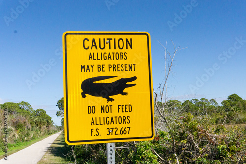 Caution alligator sign on Florida bike path photo