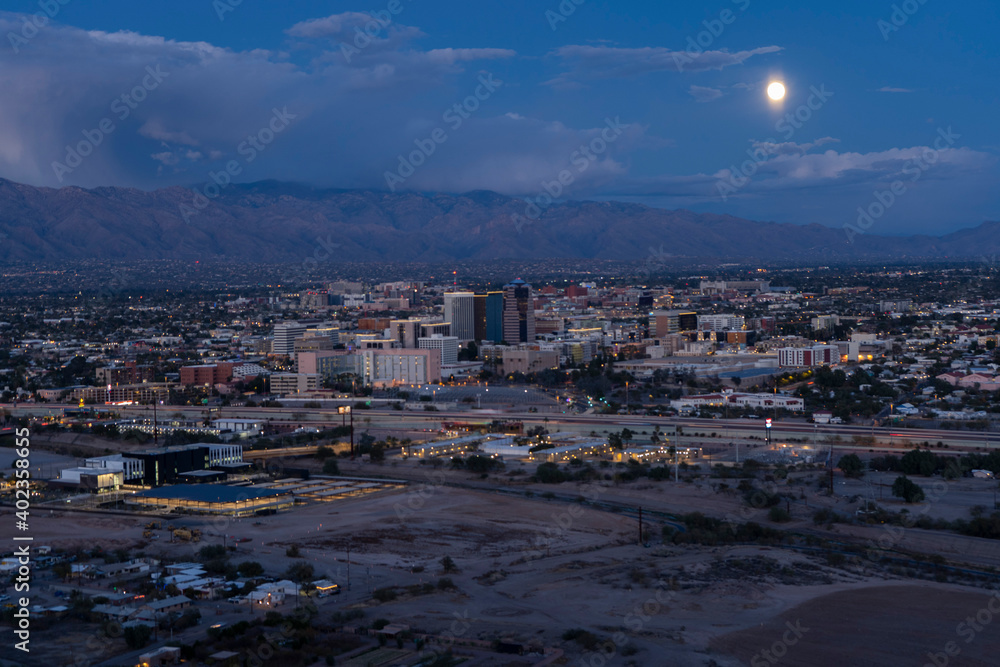 The moon rising over the city of Tucson, Arizona at dusk