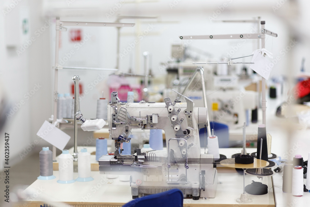 Professional sewing machine with thread in workshop. Professional sewing machine with thread in workshop.