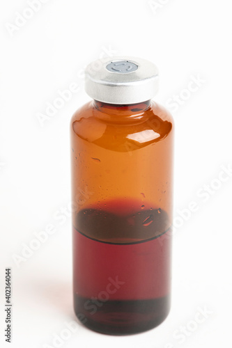 Macro Image Of Amber Vaccine Vial In White Background