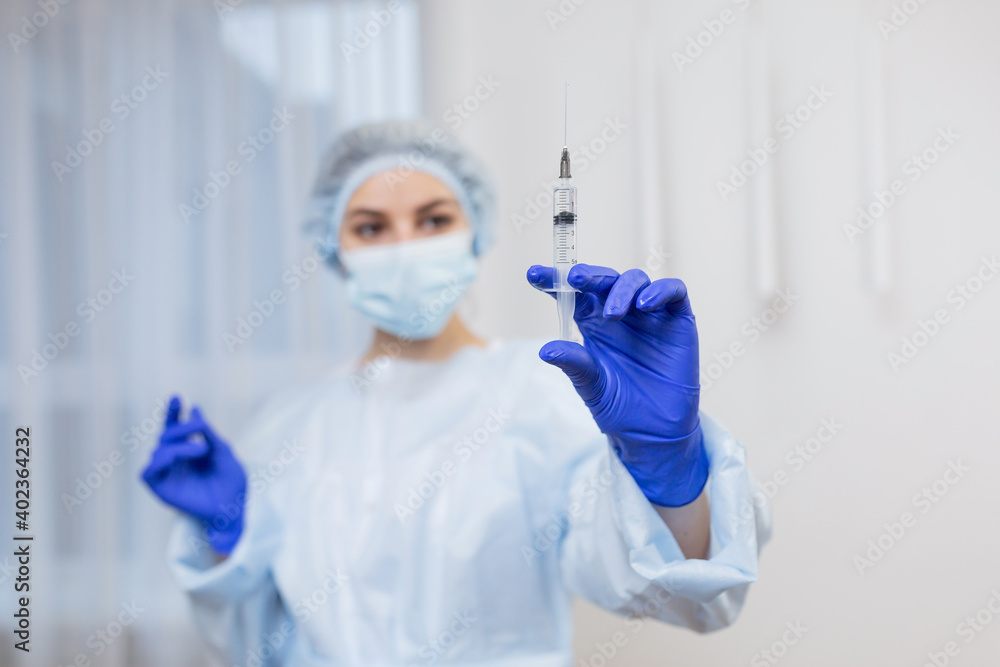 close up of female doctor holding syringe with injection, Young woman-doctor in medical uniform and gloves holds an injection in her hands. healthcare and medical concept close up of female doctor holding syringe with injection, Young woman-doctor in medical uniform and gloves holds an injection in her hands. healthcare and medical concept