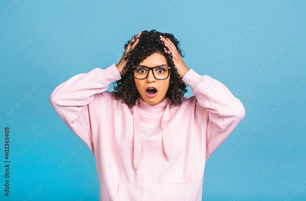 OMG! Surprised shocked amazed beautiful black african american woman isolated over blue background. OMG! Surprised shocked amazed beautiful black african american woman isolated over blue background.