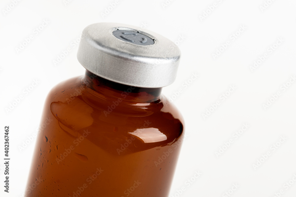 Macro Image Of Amber Vaccine Vial In White Background Macro Image Of Amber Vaccine Vial In White Background