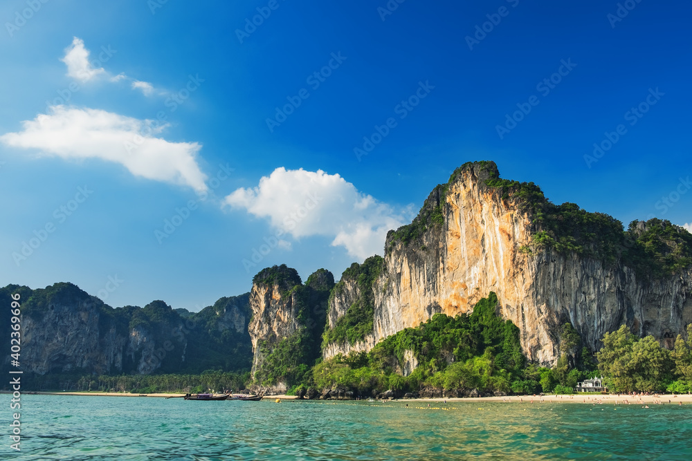 Thai beach nature landscape, exotic scenery with rocks and blue waters of Andaman sea in Krabi Province, Thailand. Panoramic beachside day view of paradise tropic island. Selective focus on coastline