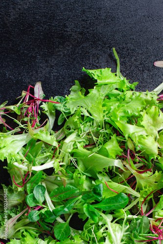 Healthy salad, leaves mix salad mix micro greens, juicy snack ready to cook and eat on the table for healthy meal snack outdoor top view copy space for text food background rustic image keto or paleo