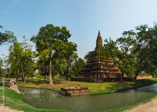 Thai Buddhist Temple Muang Boran Wat among green tropical trees  located near Wat Phra Ram in Ayutthaya historic park  Thailand. Ancient buddhist architecture  Asian traditional tourist destination