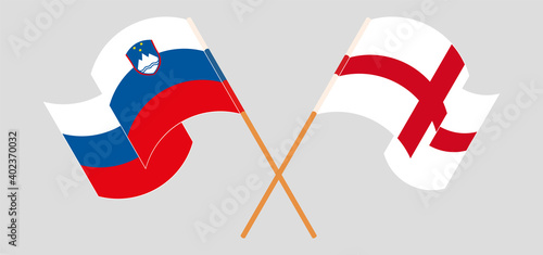 Crossed and waving flags of Slovenia and England