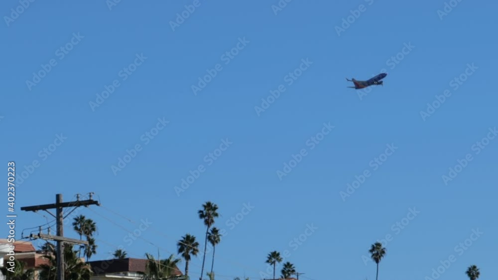 Airplane taking off from LAX over the roofs of homes on the beach Airplane taking off from LAX over the roofs of homes on the beach