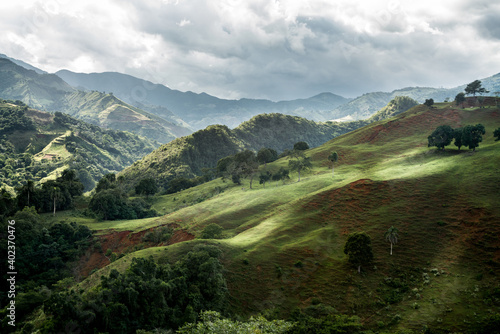 dramatic image of sunlight hitting the side of hills and mountains high in the caribbean mountains of the dominican republic.