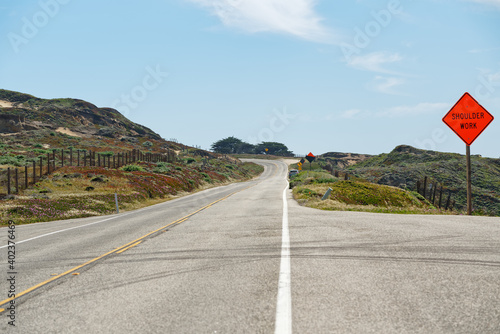 A Shoulder Work sign on the road. Monterey County, California. Scenic California State route 1