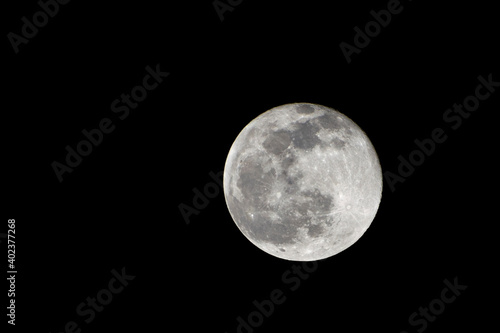 Wolf Moon. Super full moon with dark background. Madrid, Spain, Europe. Horizontal Photography. 25. January. 2024. Moon. Supermoon. Sulfur. Conjunction. Venus. Saturn. Jupiter. First moon year. photo
