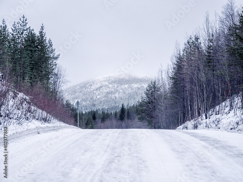 Empty the slippery winter road, a steep climb up the hill. © sablinstanislav