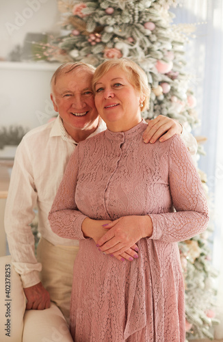 portrait of happy mature couple at home on Christmas holidas photo