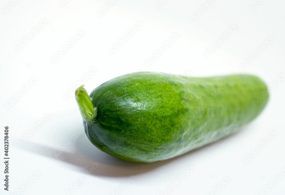 Macro of Single, Green, Ripe Cucumber on White showing Stem Detail Macro of Single, Green, Ripe Cucumber on White showing Stem Detail