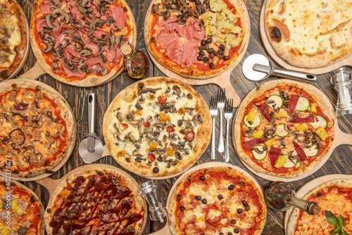 overhead shot of pizzas on dark wooden table