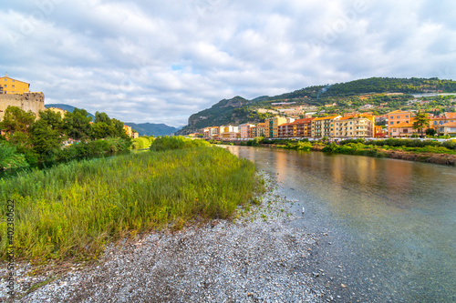 View from the bridge across the river Roya of the village of Ventimiglia, Italy, and inland to the mountains of the Imperia region.