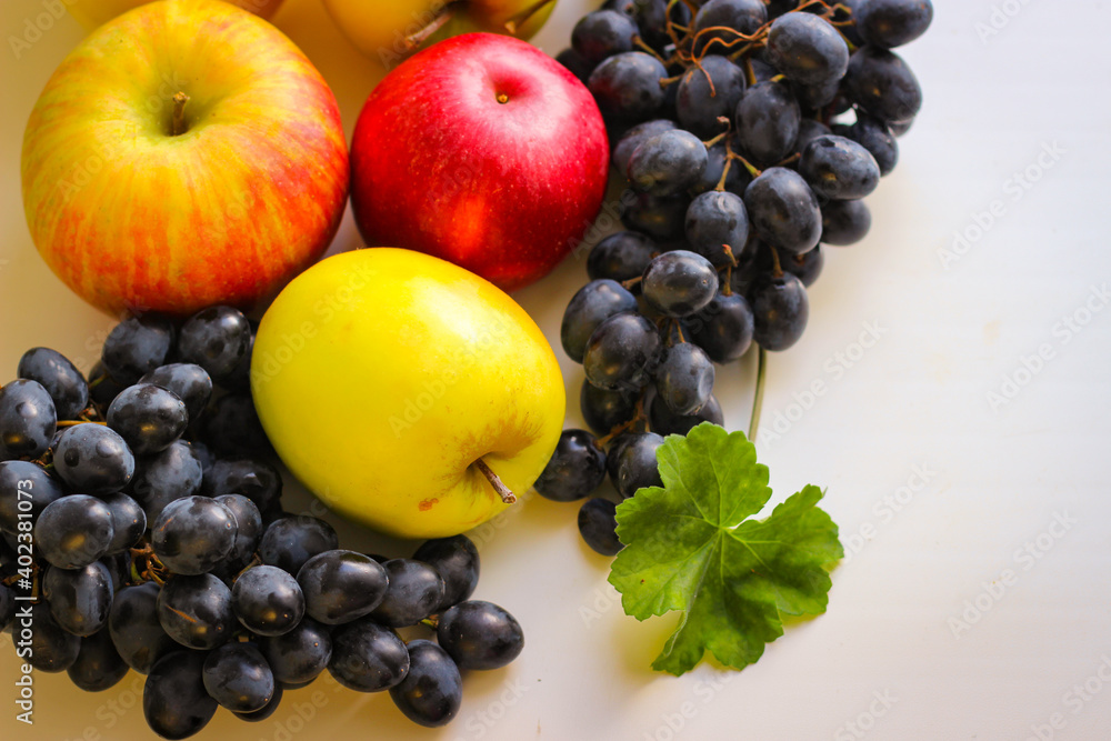 Fall fruits still life. Grapes and apples on a light background with room for copying Fall fruits still life. Grapes and apples on a light background with room for copying