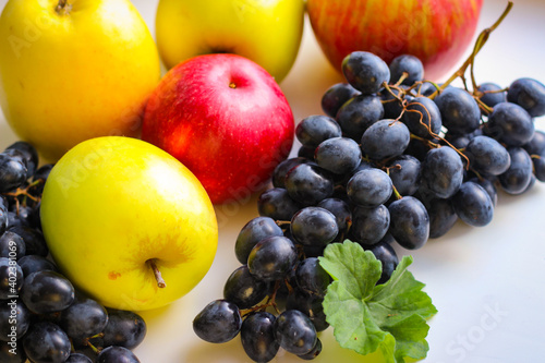 Fall fruits still life. Grapes and apples on a light background with room for copying