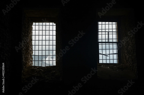 Metal bars in jail. Medieval prison with iron bars. Security grids in Dungeon. Prisoner view. Rods on a locked gate in castle. Barred doors in dungeon. Security grille as protection photo