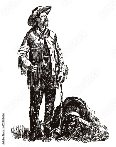 William Frederick Cody  Buffalo Bill standig beside saddle  holding gun