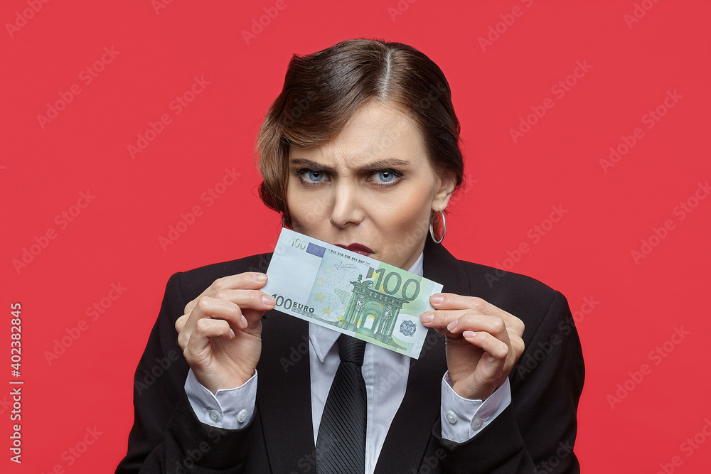 Attractive girl in retro style sniffs 100 euro bill Attractive girl in retro style sniffs 100 euro bill