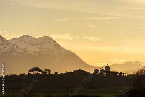 Rural scene of barn and silo in the mountains during sunset in Trevelin, Patagoni, Argentina photo