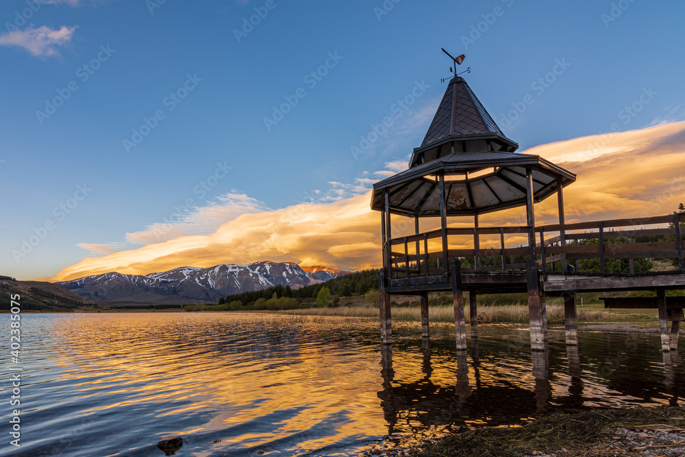 Colorful lenticular clouds over the lake during sunset in Esquel, Patagonia, Argentina Colorful lenticular clouds over the lake during sunset in Esquel, Patagonia, Argentina