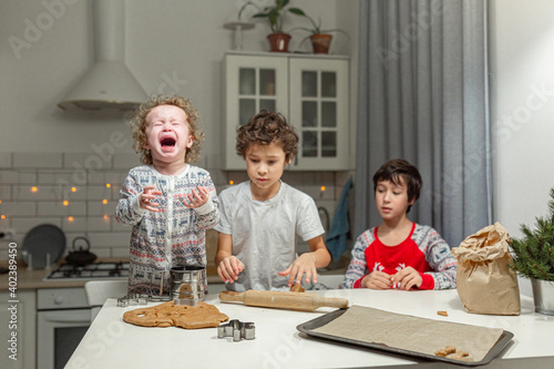 happy family funny kids are preparing the dough, bake cookies in the kitchen