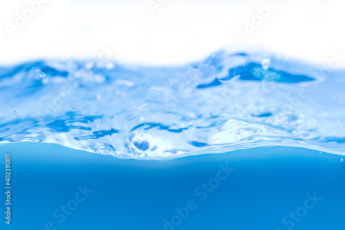 Water droplets and blue waves on a white background