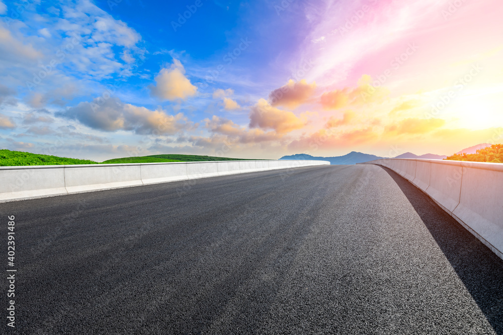 Asphalt road and mountain with tea plantation at sunset.Road and mountain background. Asphalt road and mountain with tea plantation at sunset.Road and mountain background.