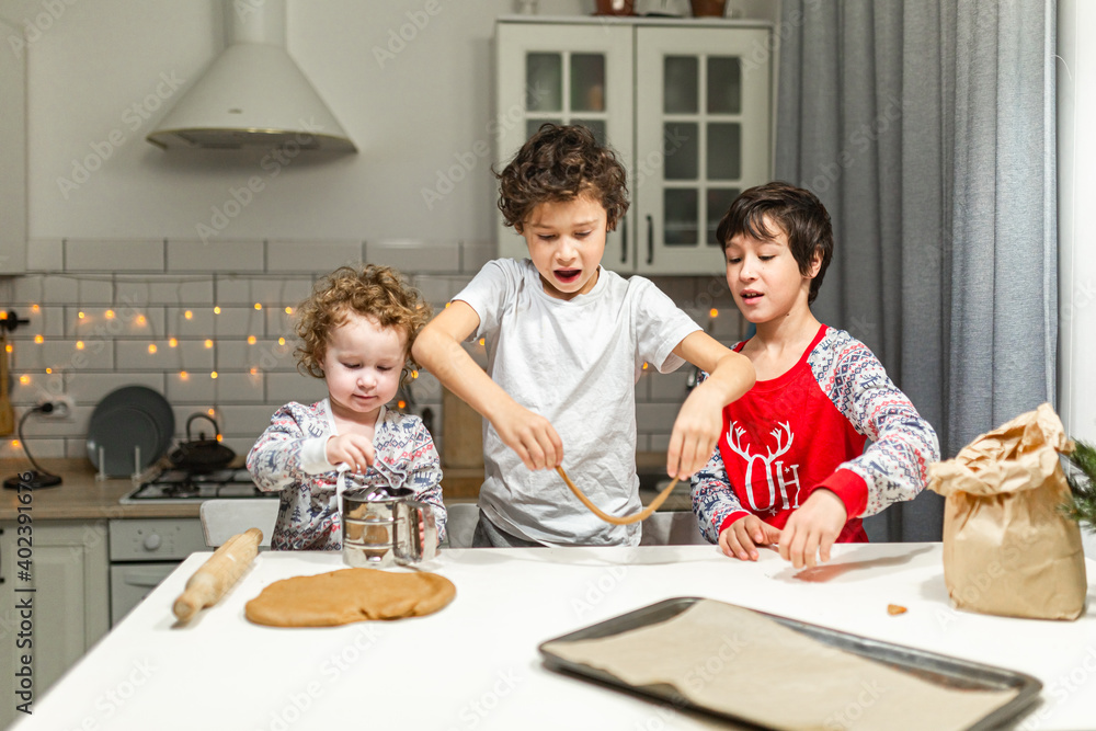 happy family funny kids are preparing the dough, bake cookies in the kitchen happy family funny kids are preparing the dough, bake cookies in the kitchen