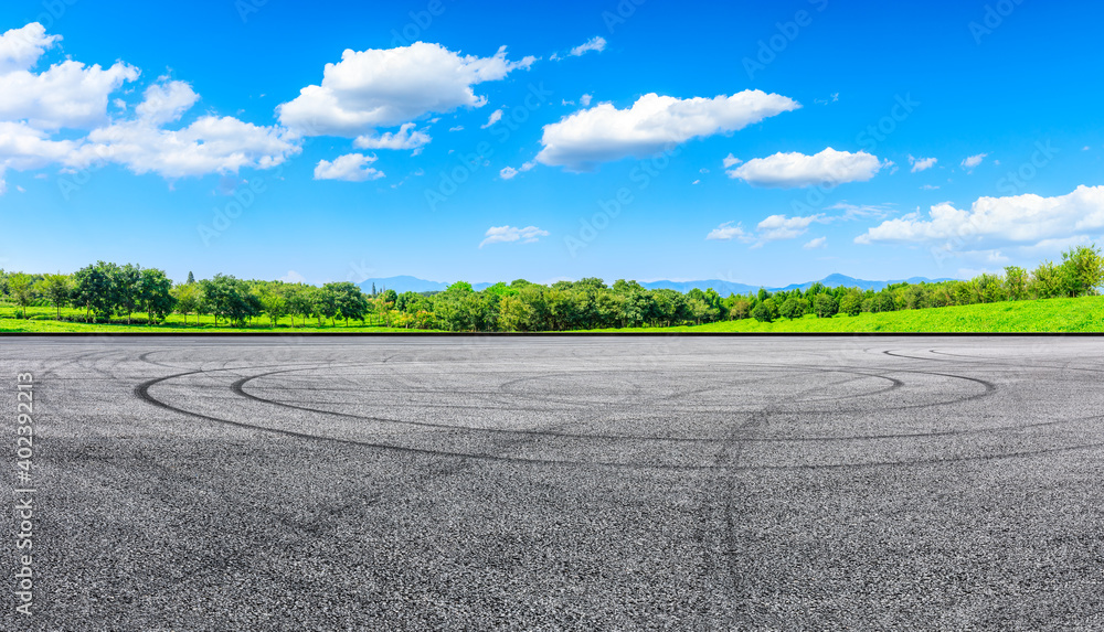 Asphalt road ground and mountain under blue sky.Race track road and mountain background.