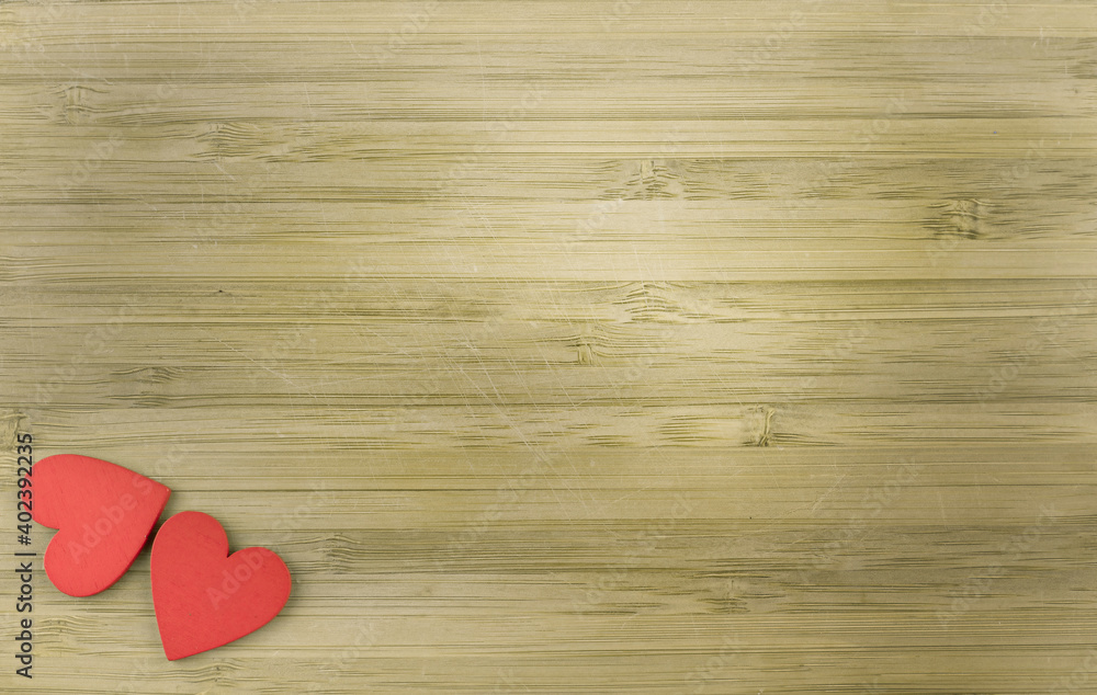 red wooden hearts on wooden background