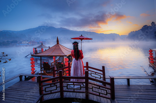 The sunrise and mist cover the reservoir at Ban Rak Thai, which is popular with tourists in Mae Hong Son Province, Thailand. photo