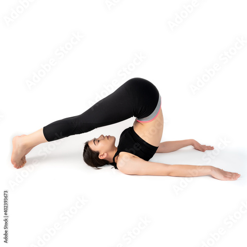 Young woman doing yoga practice isolated on white background. Flexible fit female body. Square shot. High resolution sharp photo.