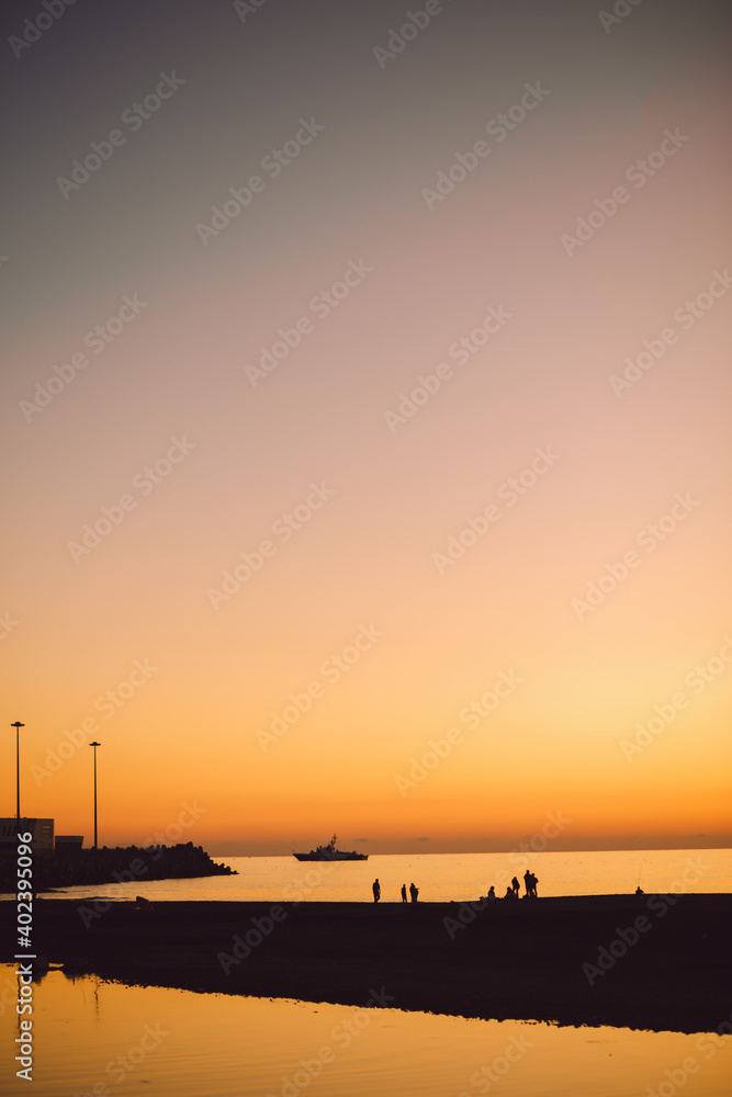 black silhouettes of people on the beach at sunset black silhouettes of people on the beach at sunset