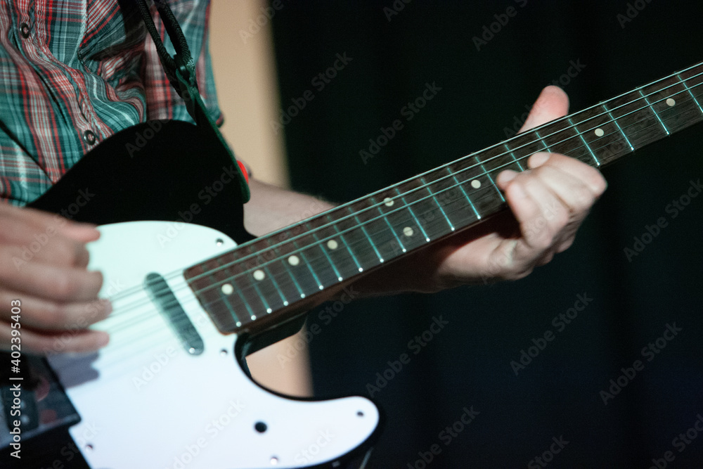 Fototapeta premium Artist guitarist, man, woman, on stage during a show.