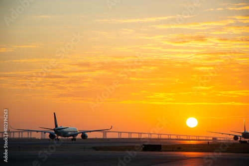 Hong Kong, 28 Dec,2020, Cathay Pacific airplane taxiing to runway with sunset background