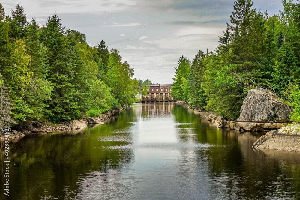 Green trees reflecting on a river at Thomson Reservoir in northern Minnesota