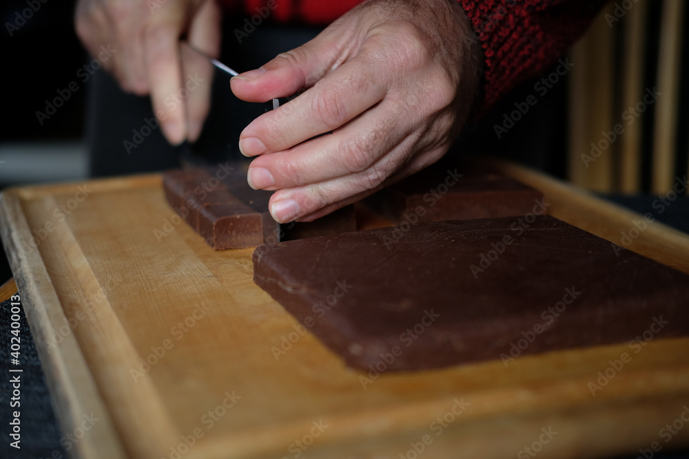 hands of a person cutting Chocolate hands of a person cutting Chocolate