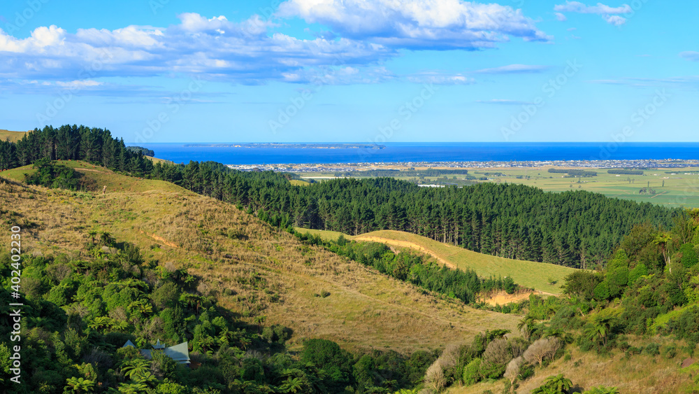 Panoramic view from the Papamoa Hills in the Bay of Plenty, New Zealand, looking towards the ocean. The coastal suburb of Papamoa can be seen in the distance